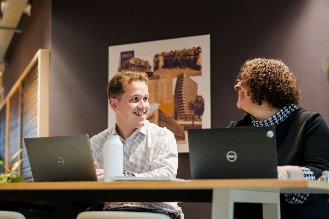 People Smiling At Desk (1)